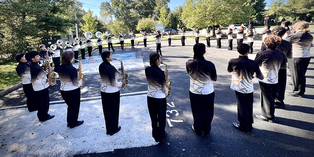 Park View Marching Band warms up in a circle